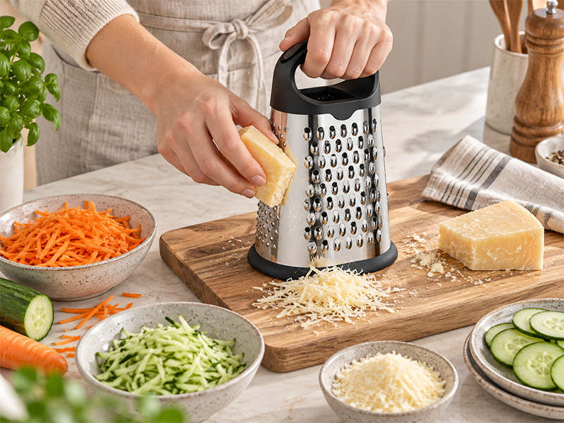 l-tools box grater used for stable food preparation with shredding and slicing functions.