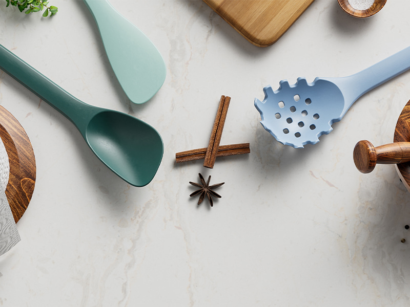 L-TOOLS wooden kitchen utensils arranged in a block holder on a countertop, emphasizing elegant storage and accessibility.