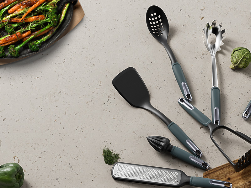 L-TOOLS assortment of kitchen spatulas, spoons, and tongs, highlighting versatile cooking tools for home use.