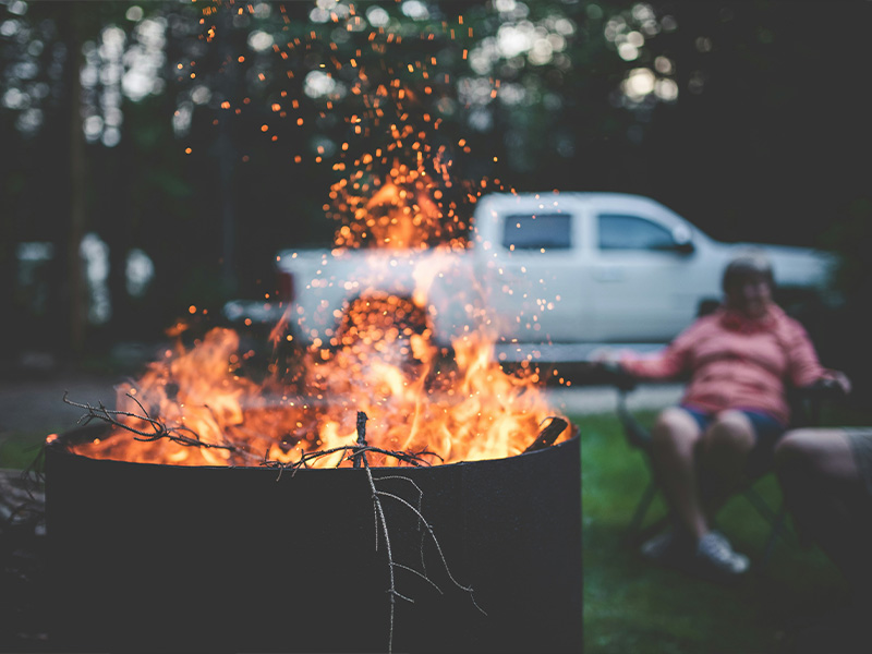 L-TOOLS outdoor barbecue fire pit with sparks and flames for outdoor entertaining.