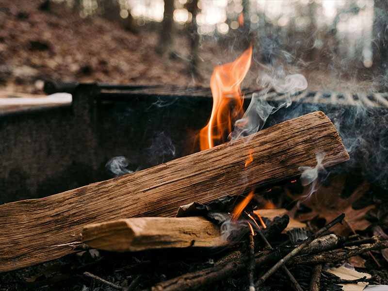 L-TOOLS firewood burning in a durable outdoor fire pit for BBQ and camping use.