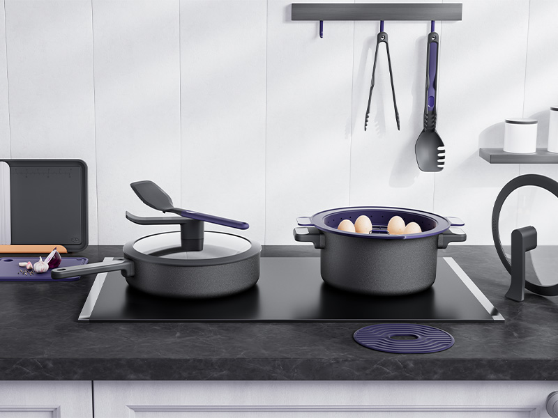L-TOOLS modern cookware set with pots, pans, and hanging utensils displayed in a sleek contemporary kitchen.