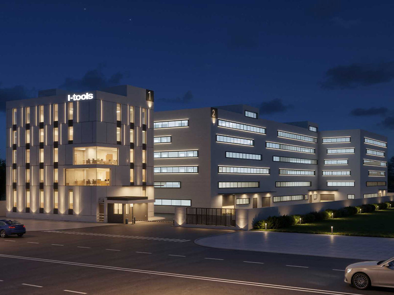 L-TOOLS modern building exterior at night, highlighting innovative architecture and lighting.