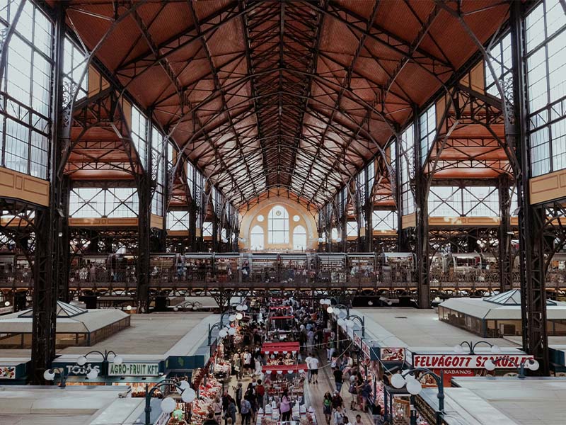L-TOOLS train station interior filled with people and open spaces, highlighting public transportation hubs.