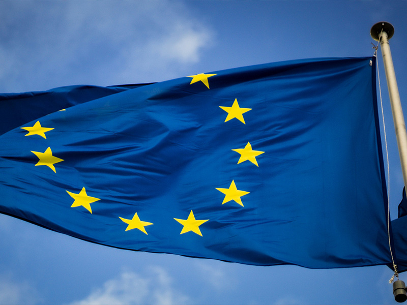 L-TOOLS European Union flag fluttering in the wind, symbolizing unity and cooperation.