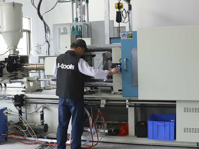 L-TOOLS factory employee operating automated machinery, highlighting advanced manufacturing systems.