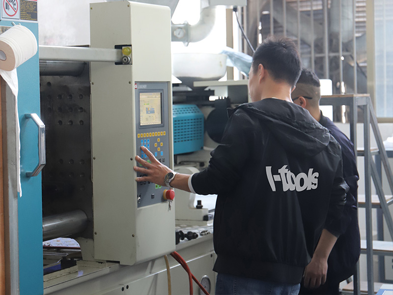L-TOOLS technician operating automated machinery for high-efficiency manufacturing.