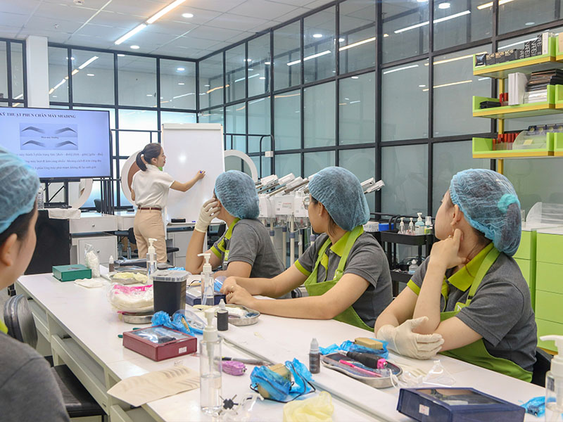 L-TOOLS modern production line with workers assembling products in organized manufacturing environment.