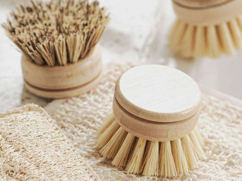L-TOOLS set of wooden cleaning brushes on a counter, showcasing eco-friendly kitchen tools.