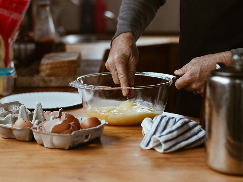 L-TOOLS hands rolling out dough for ring-shaped pastries, demonstrating artisanal baking.