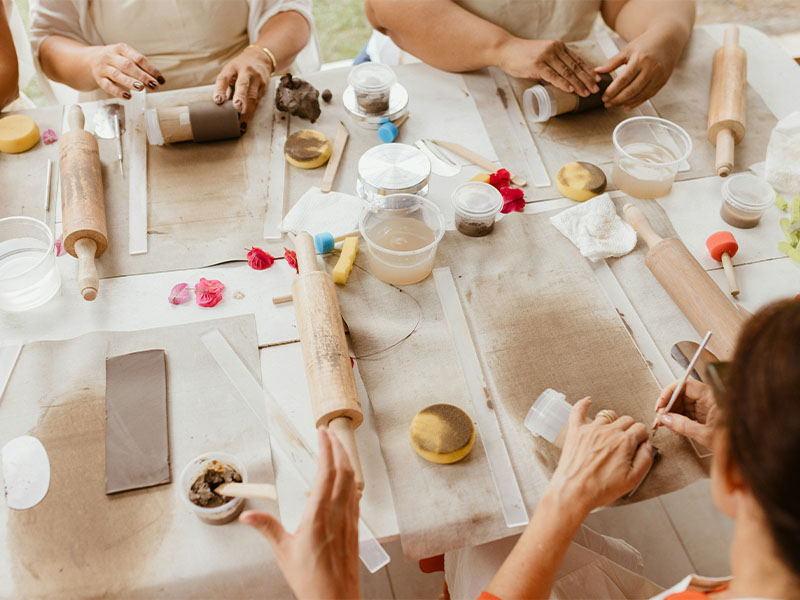 L-TOOLS family baking session with hands shaping cookie dough on a table, highlighting togetherness.