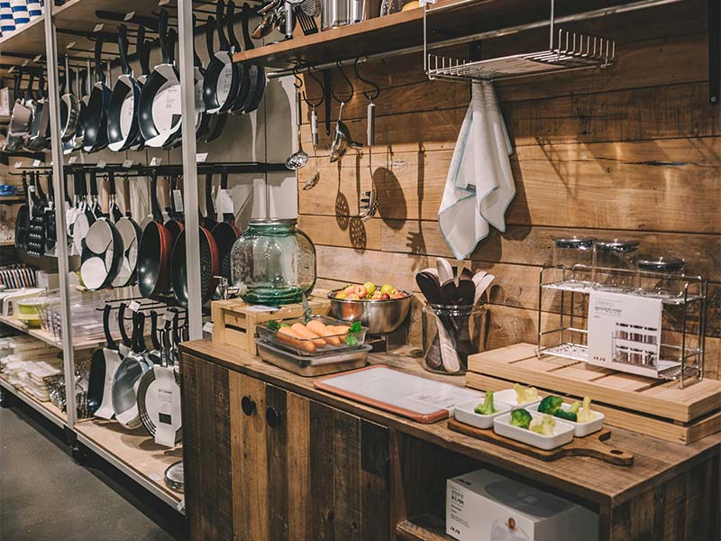 L-TOOLS rustic kitchen workspace with hanging cookware and utensils, highlighting culinary craftsmanship.