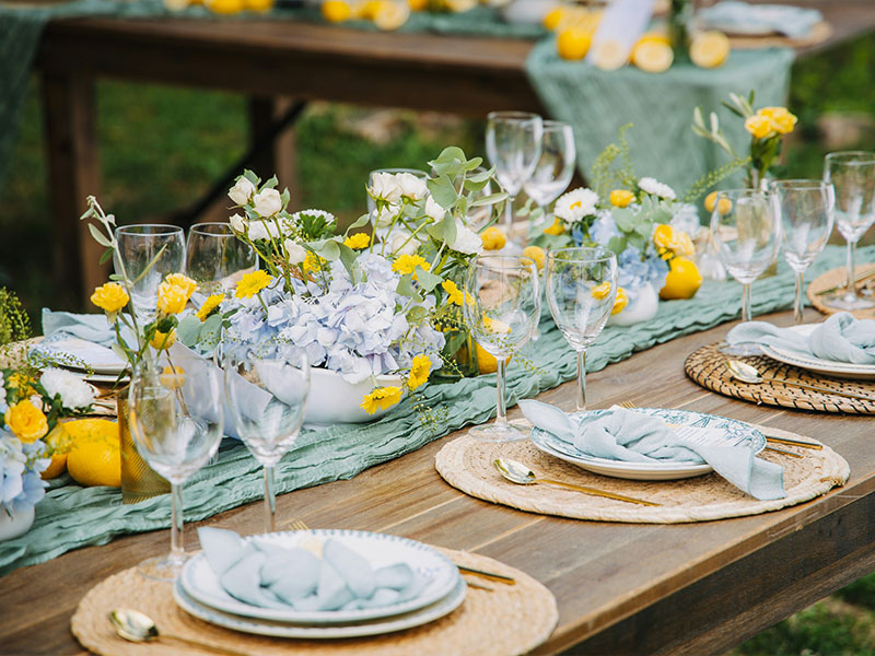 L-TOOLS wine glasses and floral centerpiece arranged elegantly on a wooden table for formal dining.