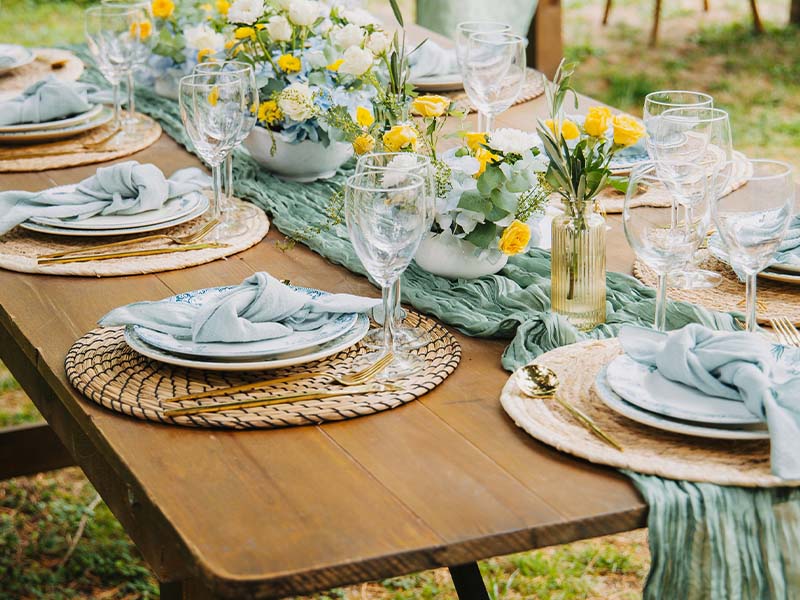 L-TOOLS detailed view of table setting with glassware and floral arrangements, emphasizing refined presentation.